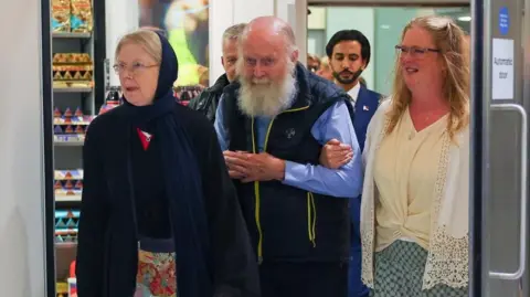 British Couple Released from Taliban Detention Returns to the UK