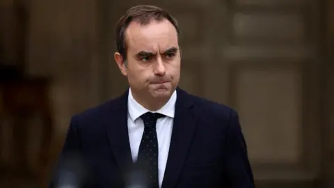 French Prime Minister Secures Vital Budget Vote Amidst Political Turmoil