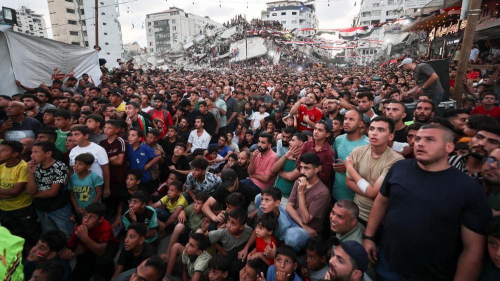 Palestinians in Gaza City watch a World Cup match between Argentina and Egypt